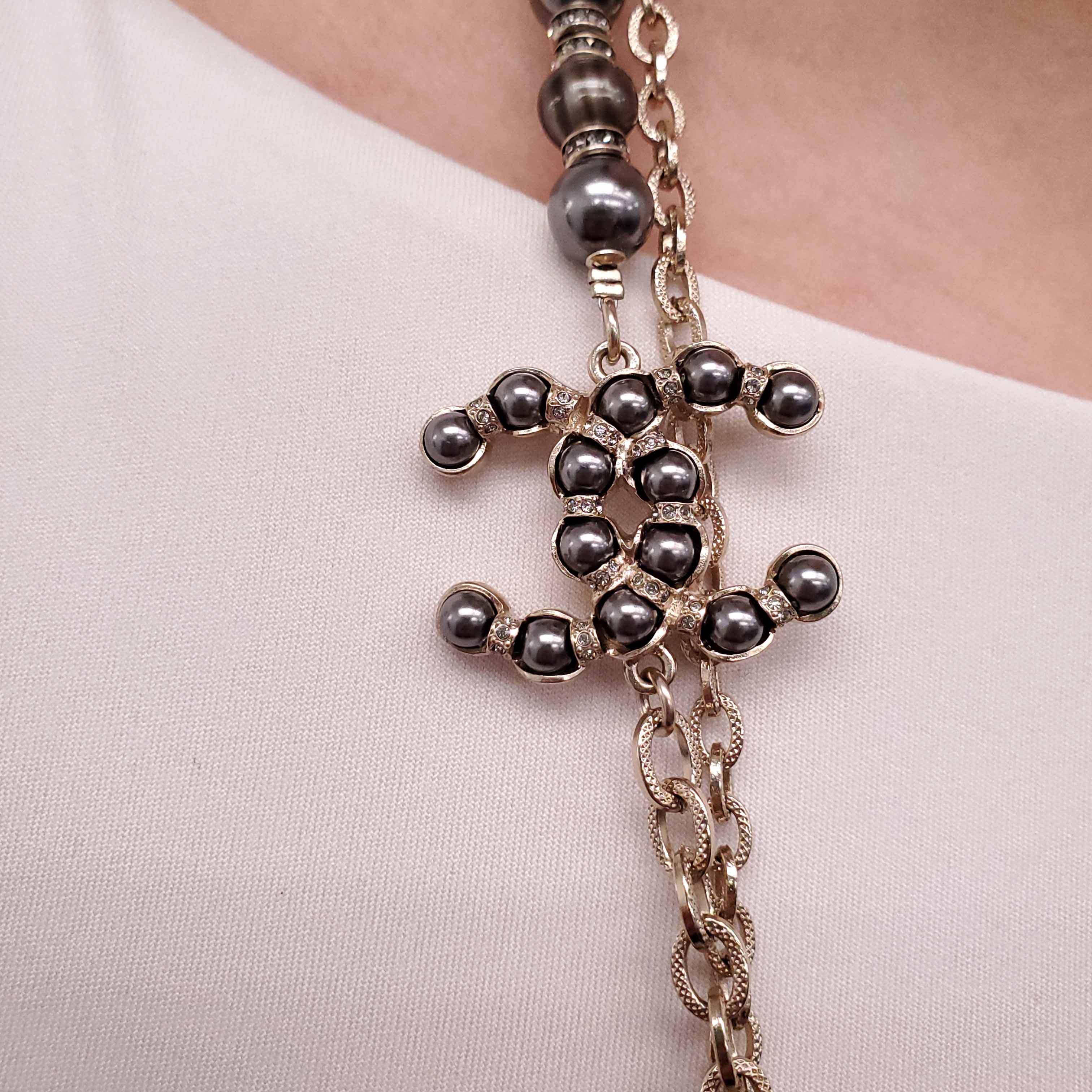 CHANEL GOLD, BRONZE, AND GREY LAYERED PEARL NECKLACE WITH CRYSTAL LOGOS