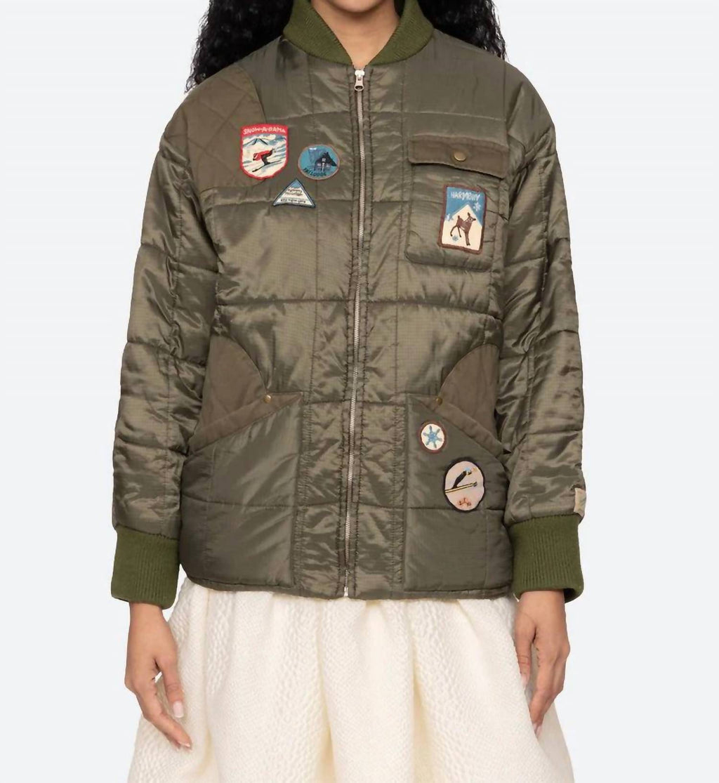 Eira Quilted Patched Puffer Jacket In Sea